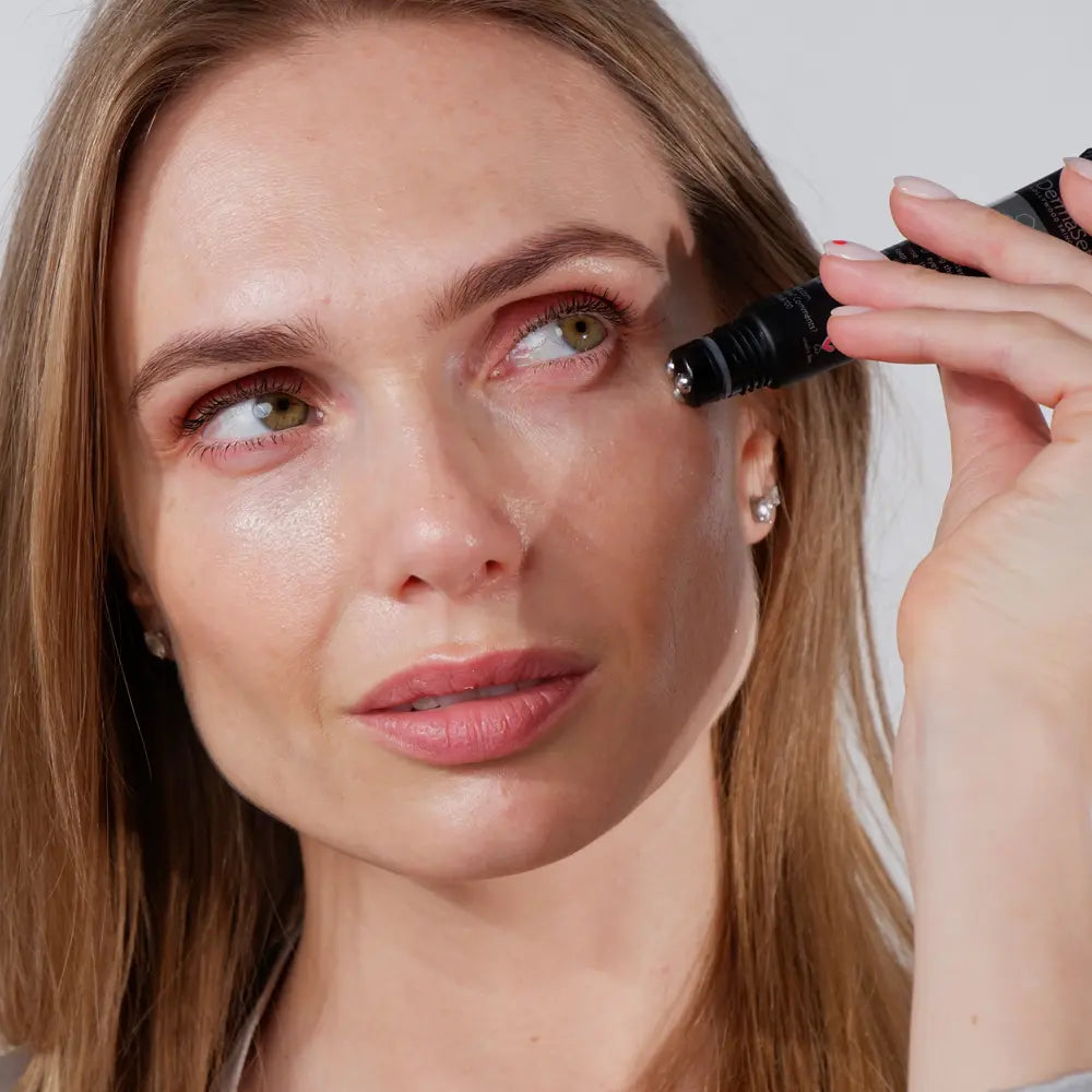 Woman applying DermaSet 3D Rollerball Eye Serum For Dark Circles & Aging Spots